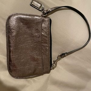Coach pewter wristlet like new 6in by  4 1/2in handle 14 in lkke brand new